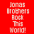 Four display 'Jonas Brothers Rock This World!' text in pixelated white font on red, purple, blue, and purple backgrounds