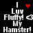 Black background with white pixelated text reading "I Luv Fluffy! My Hamster!" and red heart or star-like symbols changing position.