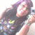A pixelated image of a person with dark hair and a dark sleeveless top, holding a colorful object with a yellow section, against a light background.