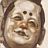 Pixelated static icon of a person's face with closed eyes and a slight smile, rendered in muted brown and beige tones on a light background.