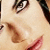 Close-up of a person's face showing eyes, nose, and lips with light skin tone and dark hair visible on the right side.