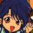 Pixelated anime-style character with dark blue hair, large brown eyes, and a red mouth, set against a blurred background.