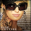 A close-up of a person wearing large dark sunglasses, a black headband, and a large floral earring, with 'DIOR COUTURE' text at the bottom.