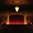 A pixelated image of a theater stage with a glowing light fixture above a wooden proscenium arch, set against a dark background.