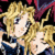 Pixelated image of two anime-style characters with long blonde hair, one in blue clothing and the other partially visible against a dark background with red accents.