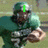 A football player in a green uniform holding a ball, with changing text overlays