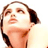 Pixelated close-up of a person's face with brown hair and light skin tone, static single-frame image on white background.