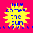 Yellow starburst shape with blue text "here comes the sun" on bright pink background, surrounded by small blue stars.