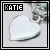 A heart-shaped pendant on a chain with the name 'KATIE' displayed in pixelated text above it, shown