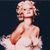 Pixelated image of a person with light hair wearing a white dress, holding a red object against a dark background.