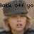 Pixelated image of a person with blonde hair wearing a gray cap and dark clothing, overlaid with black text reading "Back off yon Kyla's G".