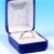 A blue and white jewelry box with a silver ring inside, set against a light blue background.