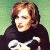 A pixelated contact sheet showing two frames of an animated icon featuring a person with brown hair and a black-and-white top on the left, next to green text reading "Original Icons .com" on a dark green background.