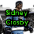Pixelated image of a person with short dark hair wearing blue jeans and a black jacket, overlaid with green text reading "Sidney Crosby" on two lines.