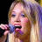 Static 48x48 pixel icon showing a close-up of a person singing into a microphone with visible facial features and hair details.