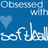 Blue background with white text "Obsessed with softball" and a light blue heart, next to a yellow softball graphic with black text asking if you wish you were like a girl.