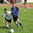 Two figures on a grassy field with one figure kicking a white ball, next to blue text reading EAT SLEEP PLAYI.