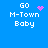 Blue background with white pixelated text 'GO M-Town Baby' and four distinct pink pixel art elements: a heart, a starburst, a scattered dot pattern, and a static dot cluster.