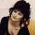 A pixelated image of a person with dark hair wearing a black top, positioned next to green text reading 'Original Icons .com' on a solid background.