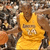 Pixelated static image of a figure in a yellow sleeveless top with brown hair, set against a blurred background of indistinct shapes and colors.
