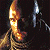 A static pixelated image shows a golden sword with a red hilt against a dark background, accompanied by a smaller silver sword on the right.