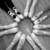 A grayscale pixelated image with a central circular shape radiating outward in multiple directions, resembling an explosion or burst pattern.