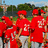 Group of people in red shirts and caps with text "Fear The Beasts!" overlaid on a pixelated background.