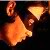 Pixelated orange and yellow flame-like shapes on a dark background with no visible text or distinct objects.