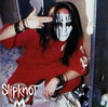 Static image of a person in red shirt with white face paint making hand gesture, text "slipknot" visible at bottom left.