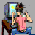 Animated sequence showing a person in a pink shirt and blue jeans sitting on a chair, with a computer monitor displaying a yellow screen, transitioning to a green glowing effect with a central circular shape.