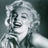 Pixelated grayscale image of a woman with curly hair and closed eyes, paired with pixelated text on black backgrounds.