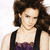A pixelated image of a woman with brown hair in a purple lace top, overlaid with text reading "Archie loves Emma Watson".