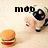 Pixelated image shows a hand holding a black camera with large lens, next to a hamburger on light background; text 'moo' appears above.