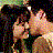 A 48x48 pixel buddy icon featuring a romantic scene with two people kissing, accompanied by text overlays on a black background.