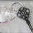 A key-shaped object with a heart-shaped bow appears on the left side of a light gray background, accompanied by text that changes across frames.