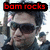 Pixelated image of a person wearing dark sunglasses and a cap, with red text reading 'boom rocks' above the head on a black background.