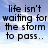 A four- displays text over a blue sky background with white clouds; the show sequential phrases about life and singing in the rain