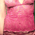 A 2x2 contact sheet of four animated frames showing a woman in a pink dress with varying poses and expressions, displayed on a gray background.