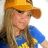 A pixelated image of a person wearing an orange cap and blue shirt with yellow text, alongside black-and-white text reading "oh my lanta" and "she is my woman."