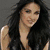 Two side-by-side images of a woman with long dark hair and light skin, wearing a sleeveless top against a gray background.