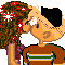 Pixelated cartoon character with brown curly hair and red starbursts, wearing a brown shirt with green stripes, holding up text reading 'Aim phuck com' in orange, yellow, and white.