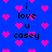 Blue background with pink pixelated hearts and black text reading 'i love u casey' in multiple scattered arrangements.