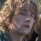 A pixelated image split into two sections: a person with curly light brown hair on the left and purple text on a light background on the right.