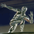 Pixelated figure in dynamic pose with arms extended, wearing camouflage-patterned clothing against dark blue background.