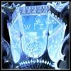 Static blue crystalline icon with shield-shaped center, glowing text elements, and ornate border details on dark background.