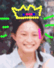 A person wearing a yellow crown with blue and pink accents, light blue shirt, and pink hair clip, shown in four sequential poses with varying head angles and expressions.