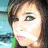 A pixelated portrait of a person with brown hair and green eyes, showing subtle facial expression changes across four views.