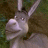 Pixelated image of a light gray animal with long ears and a rounded snout, set against a dark green and brown background.