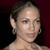 Pixelated close-up of a person with dark hair pulled back, wearing hoop earrings, against a dark red background.