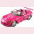 A pink convertible sports car with a driver, shown in four identical static views arranged in a on a light pink background